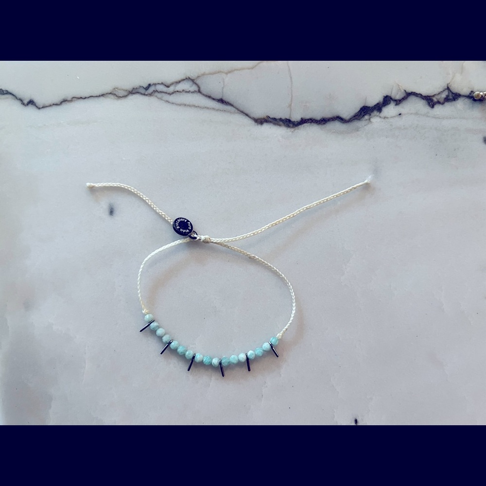 White Pura Vida bracelet with mint beads and silver beads.